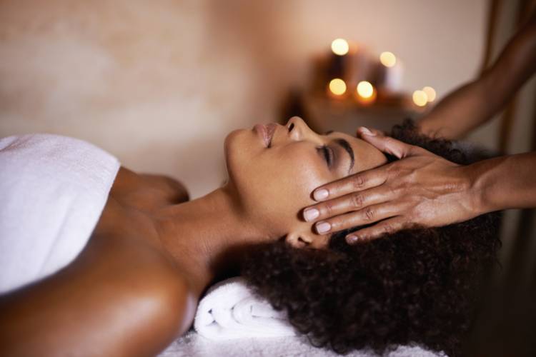 A woman getting a scalp massage after a facial spa treatment