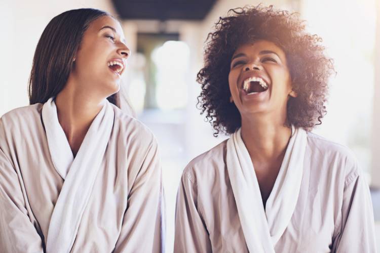 Two women laugh during their day at the spa