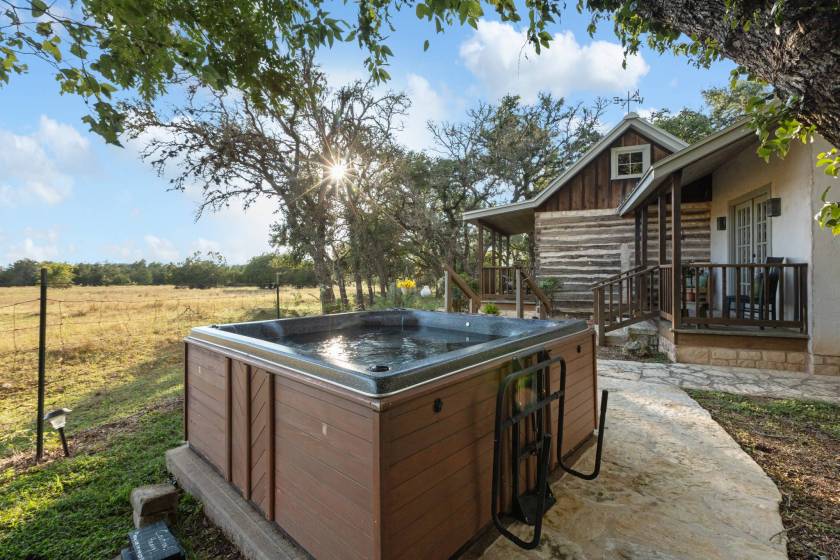 The Chula vista cabin hot tub while the sun begins to set on the Texas Hill Count
